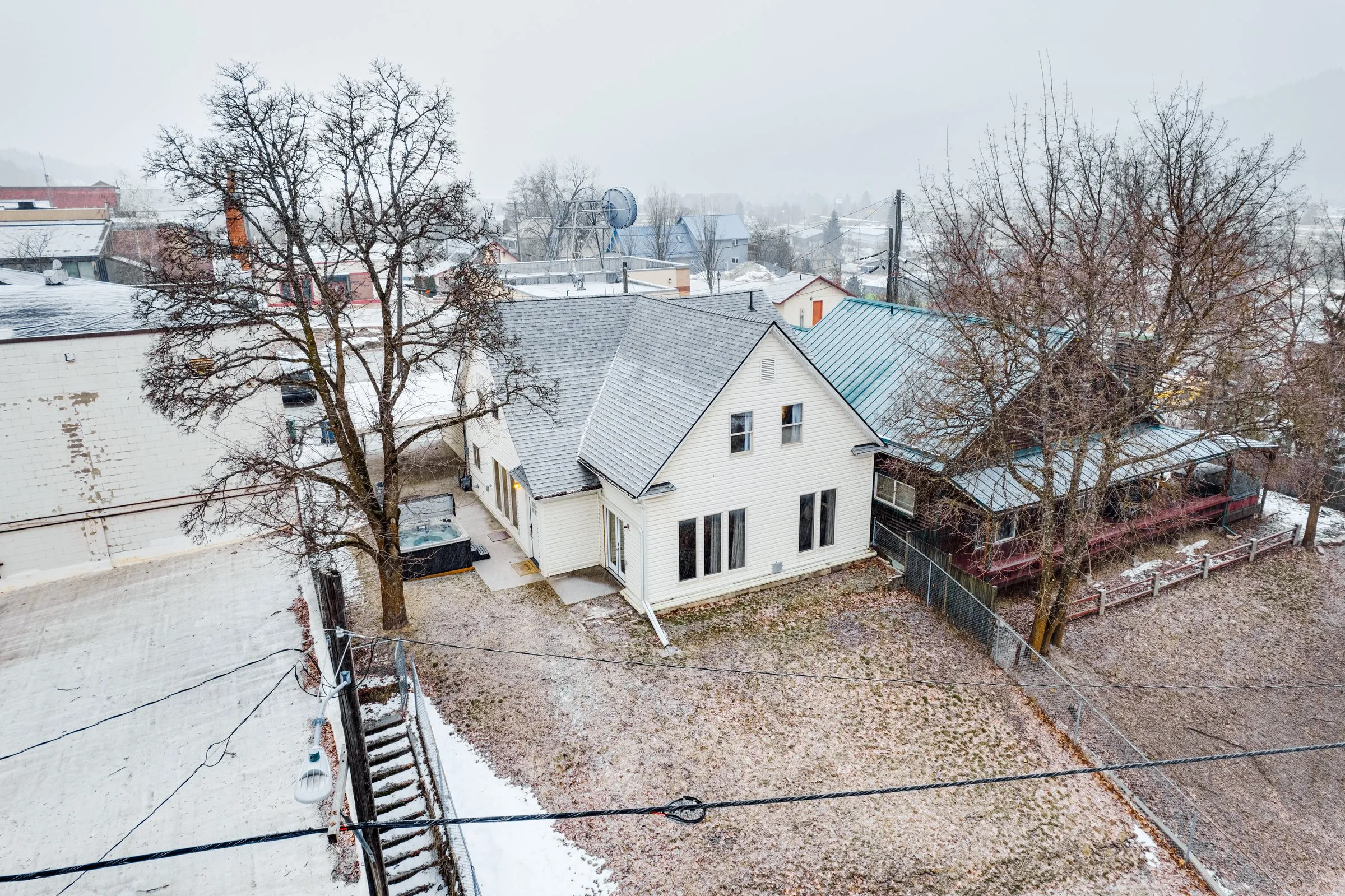 Aerial view of Kellogg, Idaho rooftops in winter around Jackass Manor